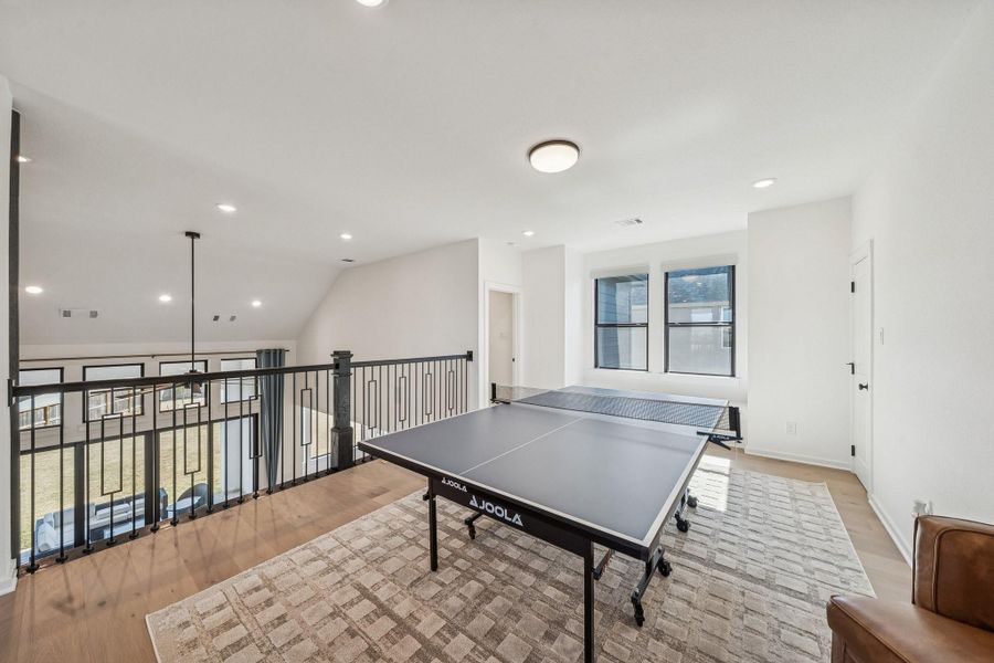 To the right is the larger of the 2 game rooms, this one is complete with large storage closet, window seat and loft that looks down to the living room.