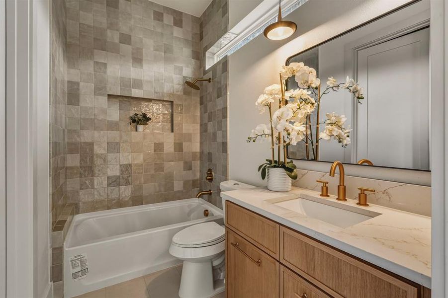 Bathroom featuring vanity, shower / bath combination, and tile patterned flooring