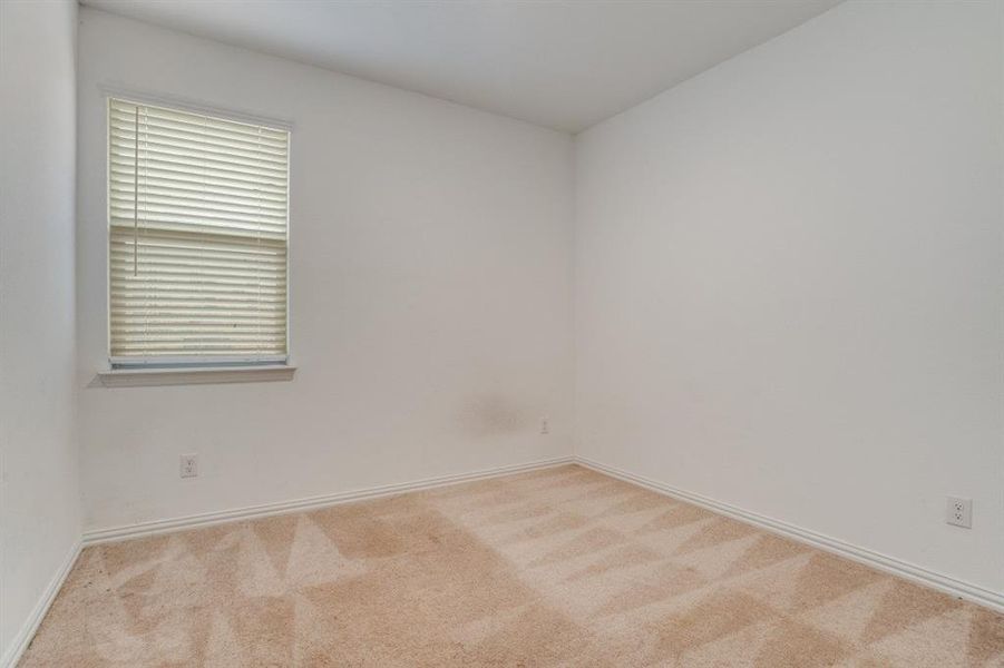 Empty room featuring carpet floors and baseboards