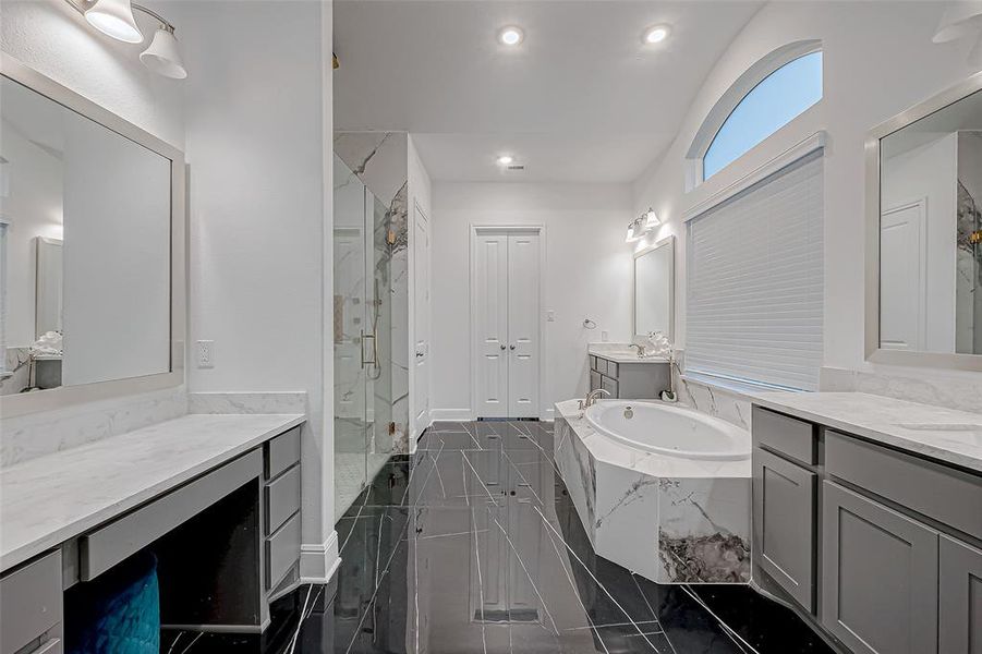 Double-door entry into the ensuite! Luxurious upgraded tile mud set shower, soaking tub, spacious double vanities, expansive walk-in closet with built-in shelving & ample hanging space.