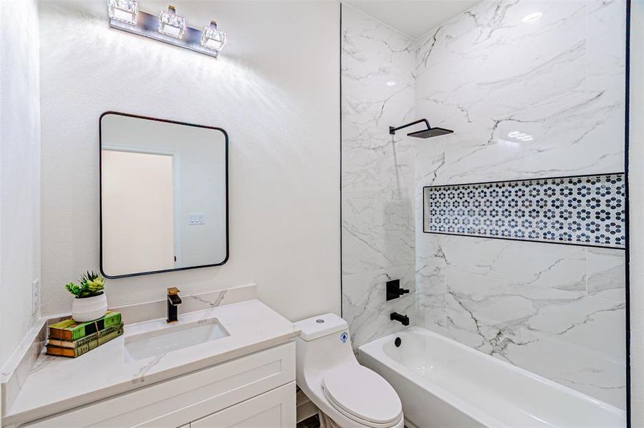 Bathroom with shower / washtub combination and vanity