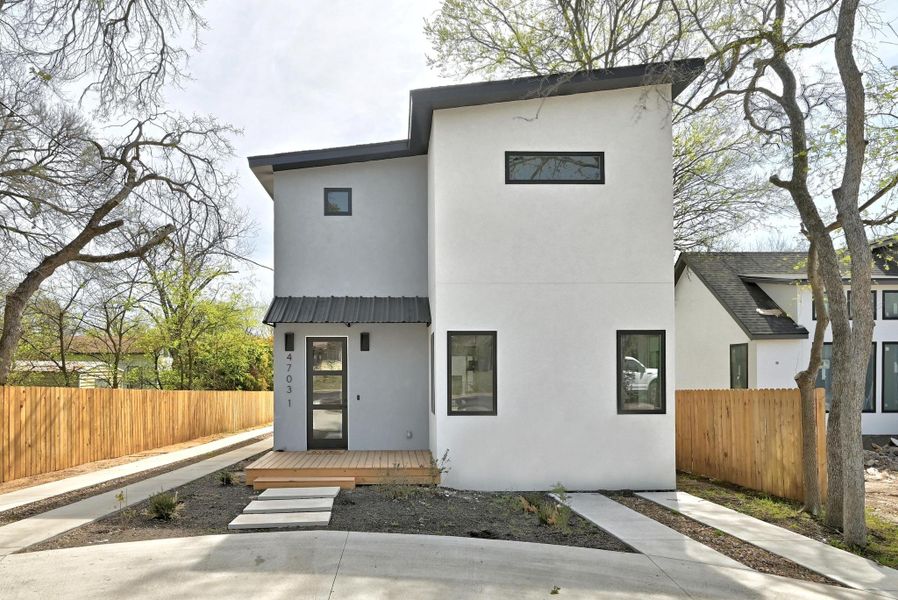 Modern home with fence and stucco siding