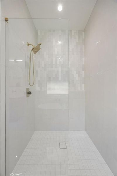 The sleek walk-in shower showcases designer tile surrounds, seamless glass, and sophisticated plumbing fixtures, creating a luxurious and spa-inspired experience. The sleek walk-in shower showcases designer tile surrounds, seamless glass, and sophisticated plumbing fixtures, creating a luxurious and spa-inspired experience.