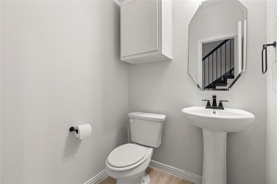 Bathroom with hardwood / wood-style floors and toilet