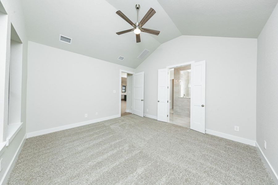 Additional view from primary bedroom looking towards the double door entrance to primary bathroom.