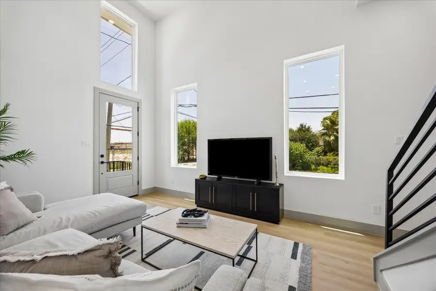 The dramatic two story living area showcases the home’s architectural scale while maintaining a warm and inviting atmosphere. The dramatic two story living area showcases the home’s architectural scale while maintaining a warm and inviting atmosphere.