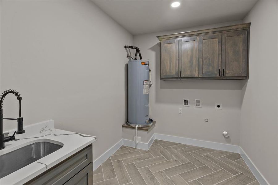 Washroom with electric water heater, electric dryer hookup, hookup for a gas dryer, hookup for a washing machine, and baseboards
