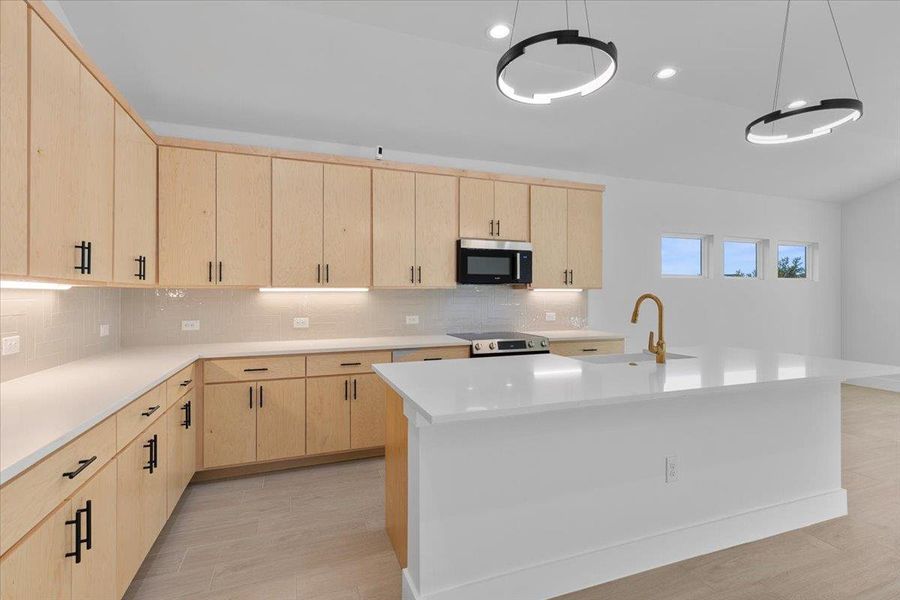 Kitchen featuring light brown cabinets, a kitchen island with sink, appliances with stainless steel finishes, decorative backsplash, and recessed lighting Kitchen featuring light brown cabinets, a kitchen island with sink, appliances with stainless steel finishes, decorative backsplash, and recessed lighting