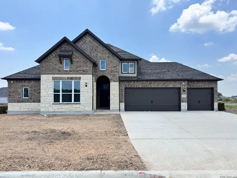 Front exterior of a new home in Megan's Landing, Castroville, TX, highlighting curb appeal (Image 1). Front exterior of a new home in Megan's Landing, Castroville, TX, highlighting curb appeal (Image 1).