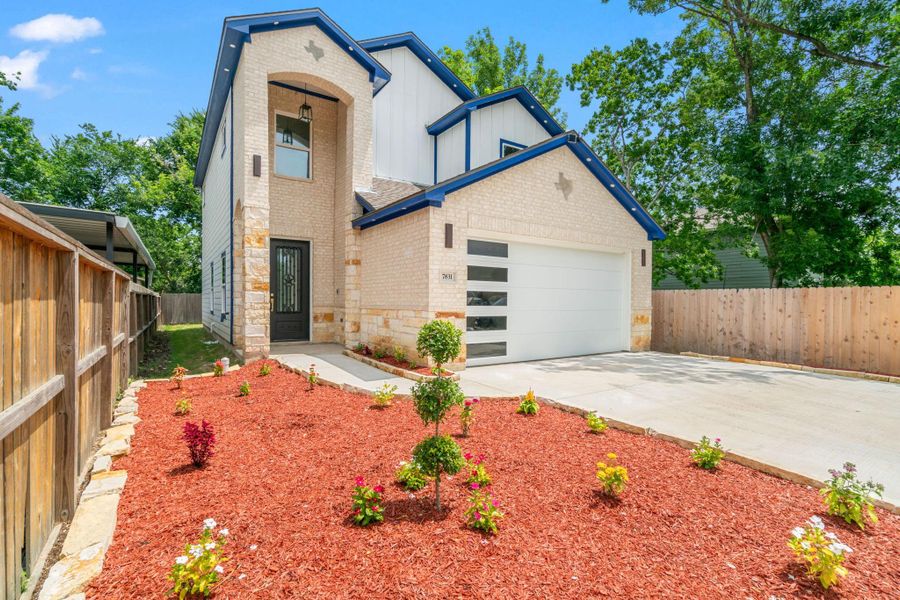 This contemporary two-story home showcases a crisp white exterior accented with bold blue trim. A wide driveway and thoughtfully landscaped front yard with fresh mulch and young greenery create a welcoming curb appeal. The modern garage and inviting entrance reflect the home’s clean, stylish design. This contemporary two-story home showcases a crisp white exterior accented with bold blue trim. A wide driveway and thoughtfully landscaped front yard with fresh mulch and young greenery create a welcoming curb appeal. The modern garage and inviting entrance reflect the home’s clean, stylish design.