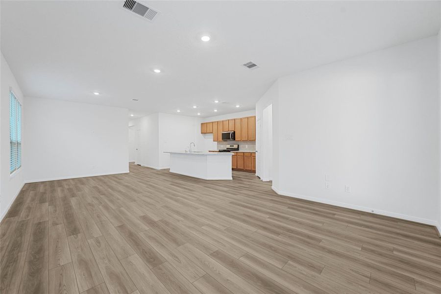 Designed for comfort and connection, this spacious open-concept great room seamlessly merges with the stunning kitchen for easy living and entertaining.