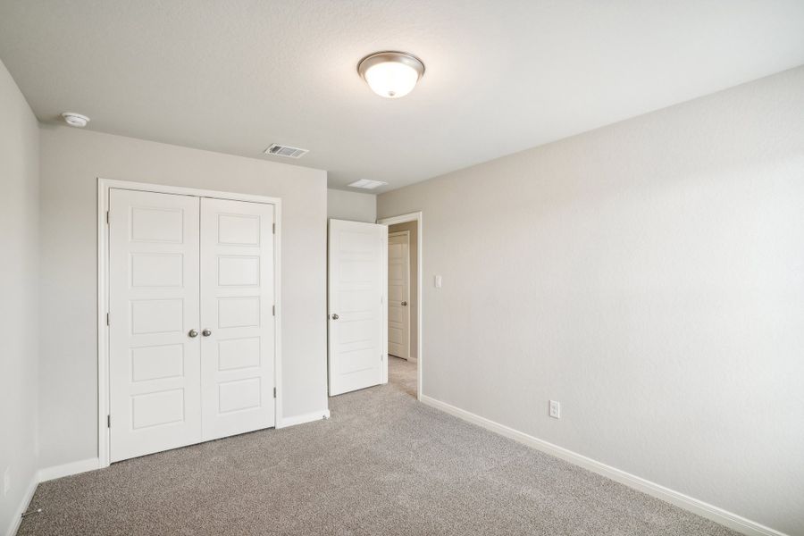 Guest bedroom of the Reynolds floorplan at a Meritage Homes community.