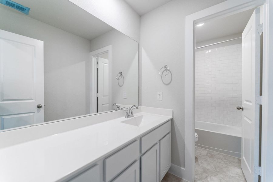 Bathroom with vanity and shower / tub combination