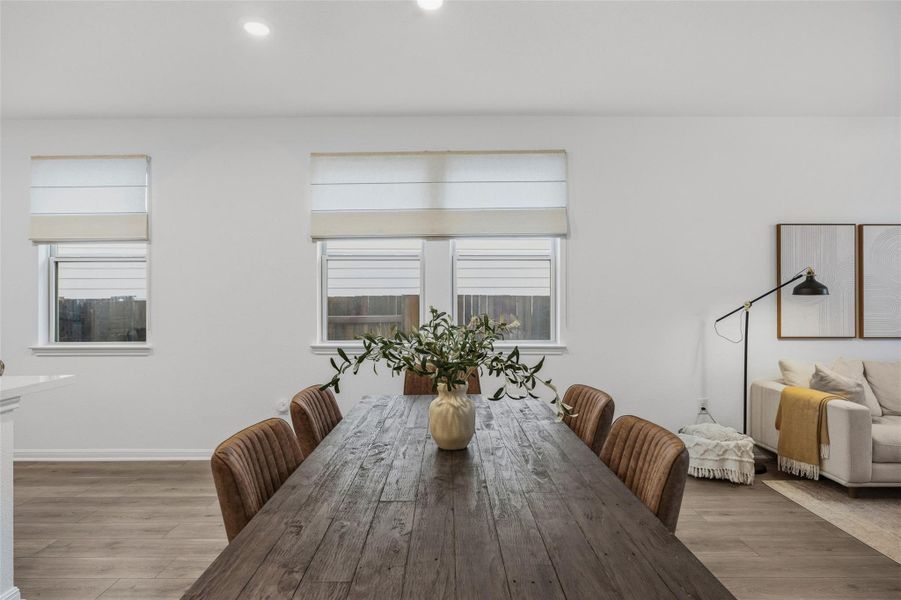 Open-concept living space with recessed lighting and wood-finish flooring