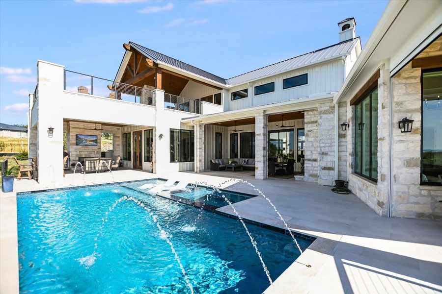 View of swimming pool featuring a patio, a pool with connected hot tub, and ceiling fan View of swimming pool featuring a patio, a pool with connected hot tub, and ceiling fan