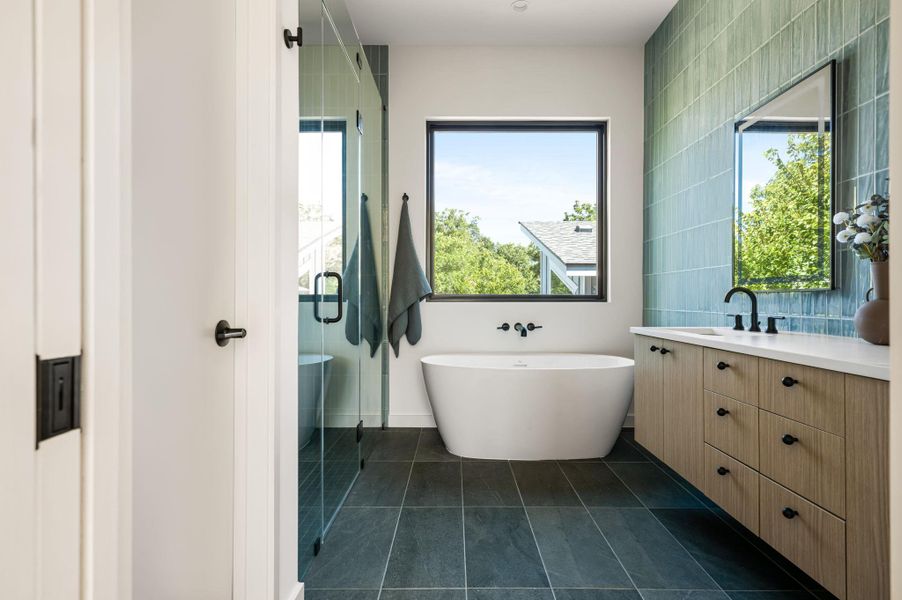 Clean lines and a freestanding soaking tub define this modern, sunlit bathroom retreat.