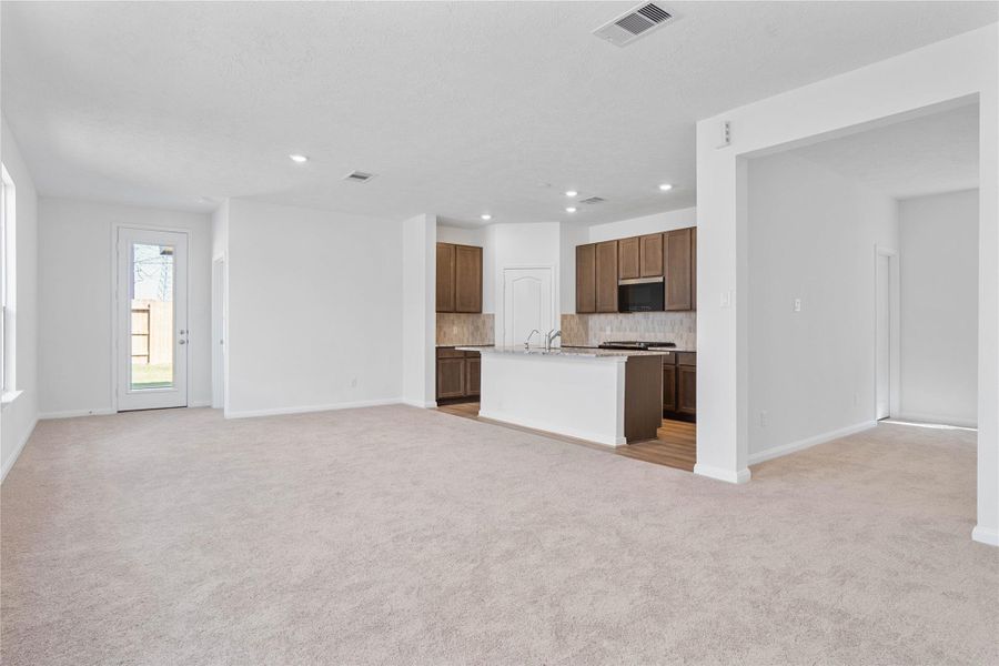 Stunning open-concept design seamlessly connecting the living, dining, and kitchen areas—perfect for both everyday living and entertaining!