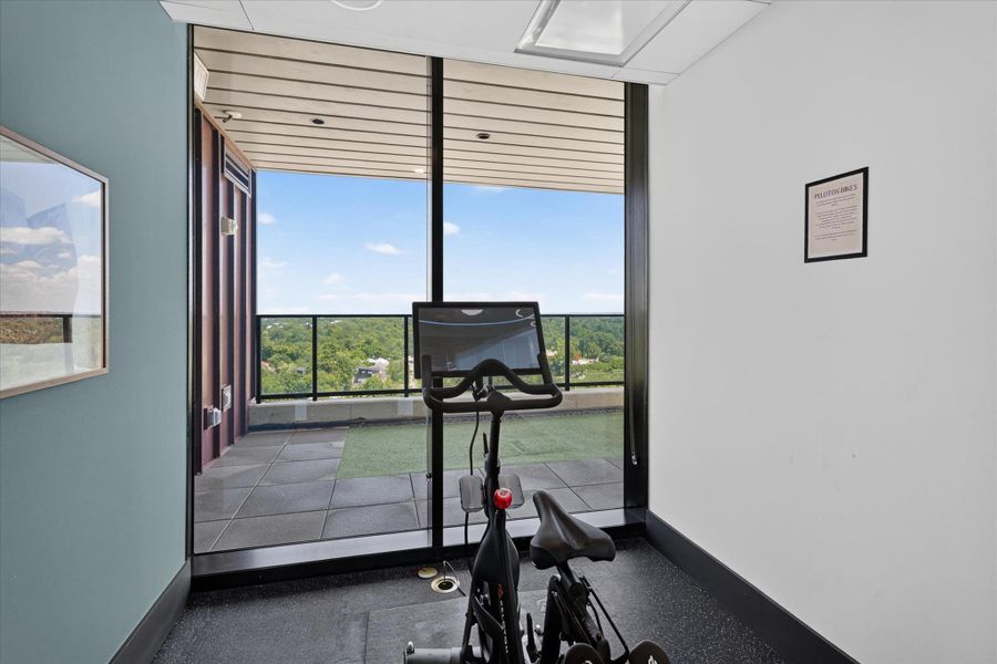 Floor-to-ceiling windows present incredible panoramic views, creating a dynamic exercise space.