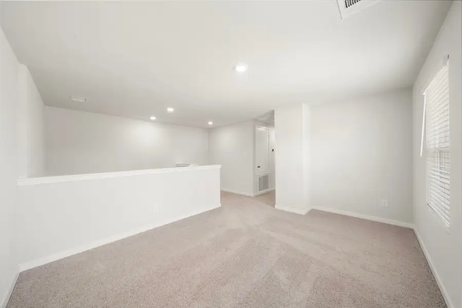 A long hallway with white walls.