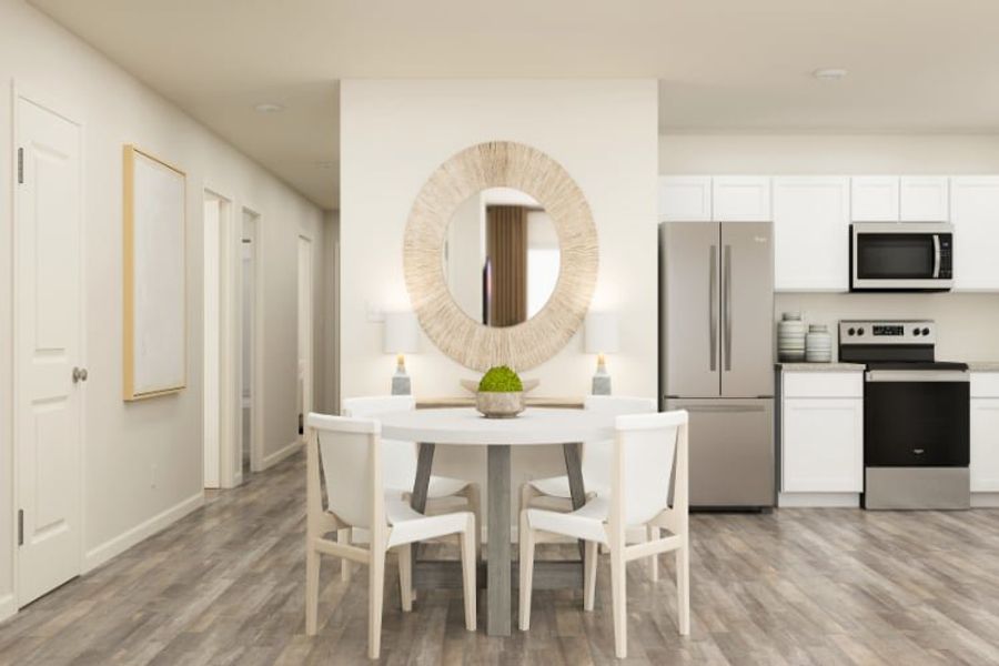 A kitchen with a table and chairs.