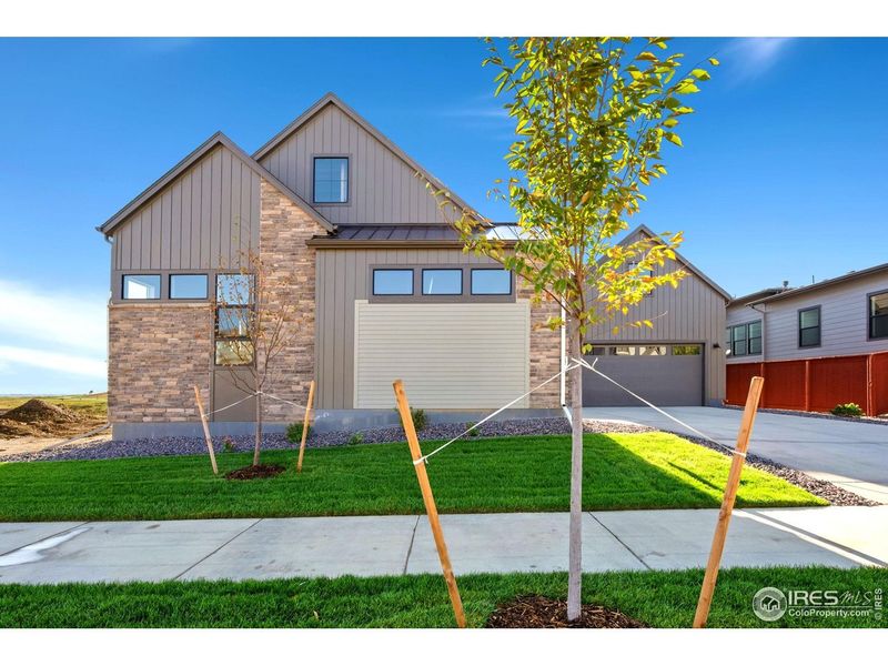 Front exterior of a new home in The Fairways at RainDance, Windsor, CO, highlighting curb appeal (Image 2).