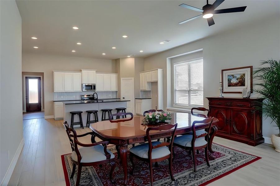 Dining area featuring a ceiling fan, recessed lighting, healthy amount of natural light, and light wood-type flooring