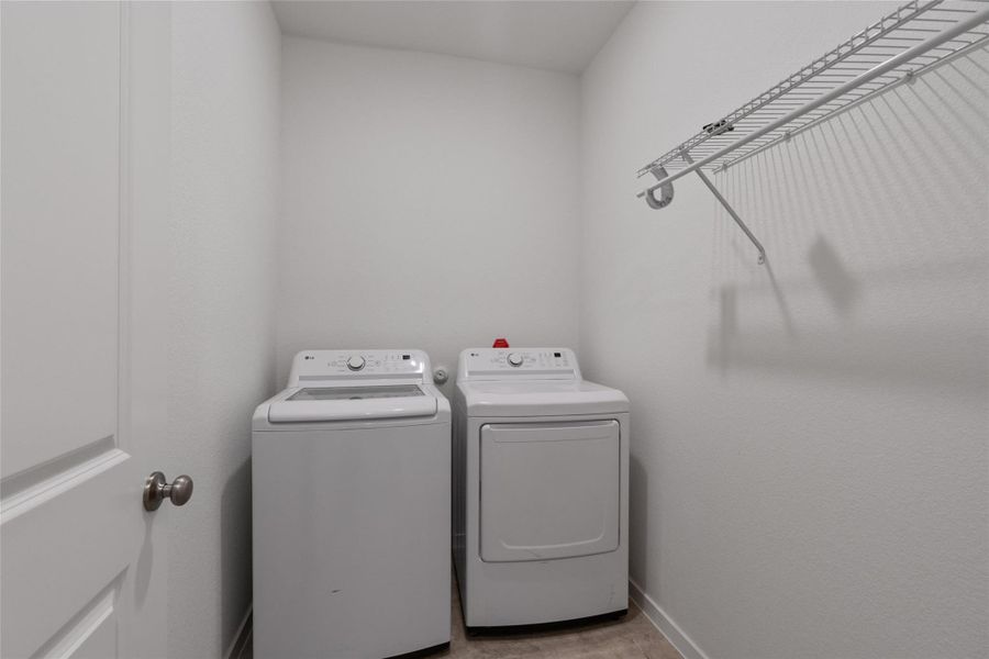 A dedicated laundry room with convenient shelving