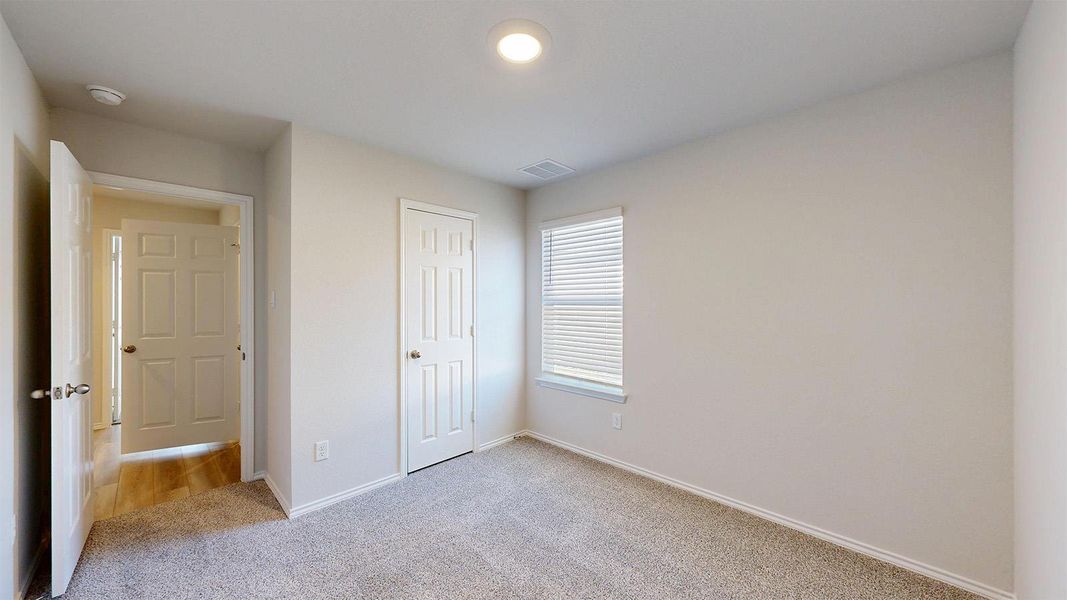 Neutral tone walls with white trim, a single window with blinds, and recessed lighting