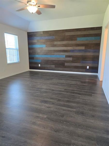 Spare room with ceiling fan and dark wood-type flooring