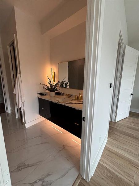 Corridor with baseboards and light marble finish floors Corridor with baseboards and light marble finish floors