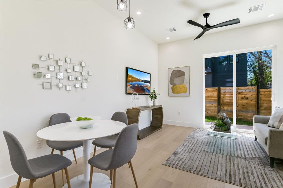 Morning coffee has never looked better. This dining nook is bathed in natural light from the sliding glass doors, accented by modern pendant lighting.