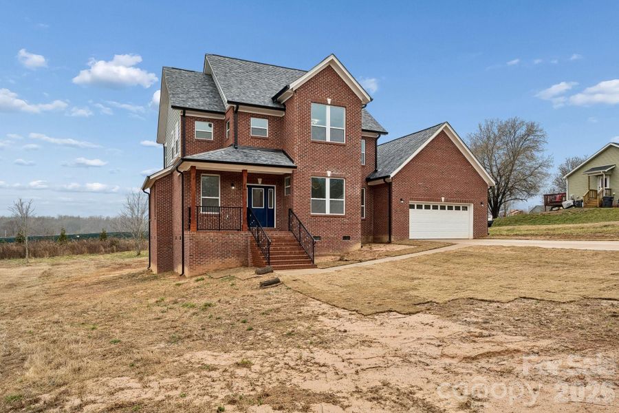 Exterior front offers 3 sides brick, extensive concrete driveway for parking and an amazing covered front porch that features rout-iron railing and cedar columns