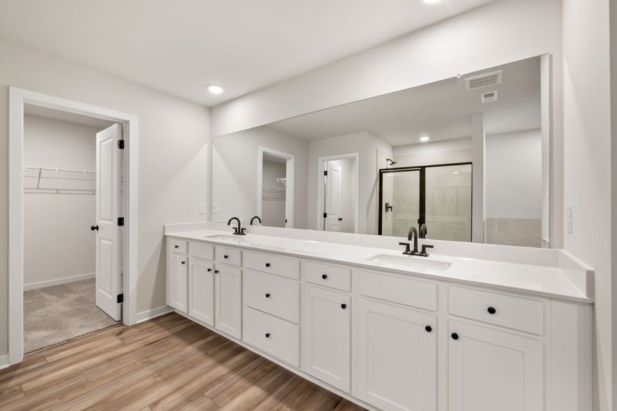 A bathroom with white cabinets. A bathroom with white cabinets.