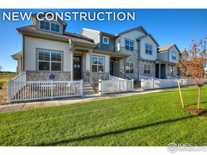 Front exterior of a new home in Highlands at Fox Hill - The Towns, Longmont, CO, highlighting curb appeal (Image 1).
