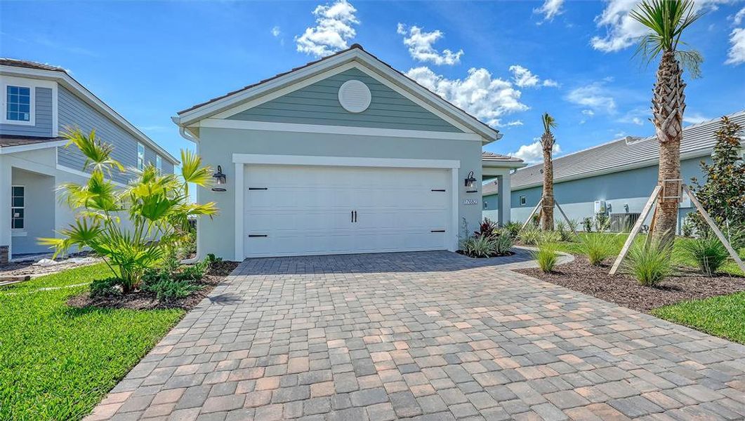 Front exterior of a new home in Palmera, Venice, FL, highlighting curb appeal (Image 2).