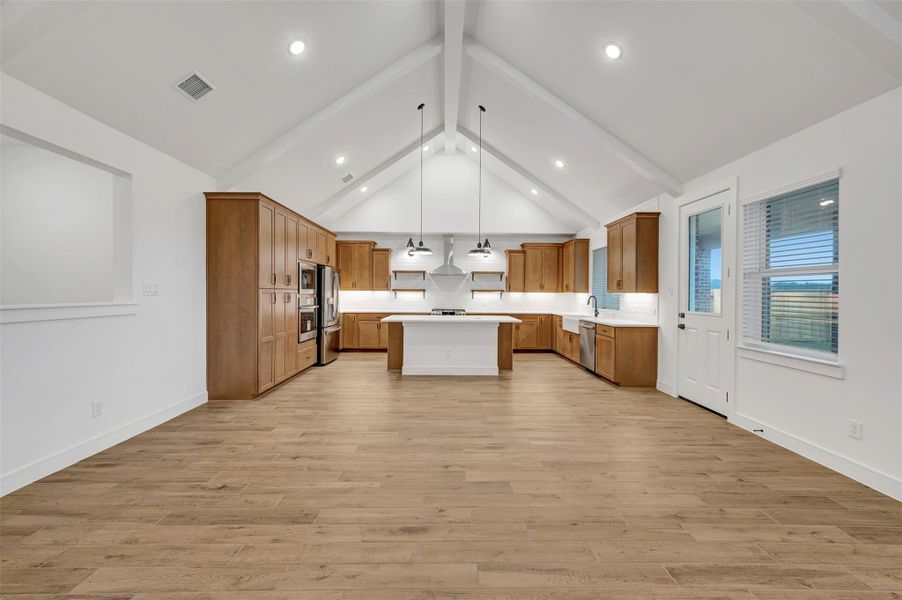High ceilings with painted beams throughout the living area