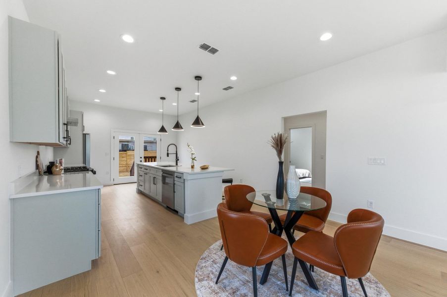 Dining area with recessed lighting and light wood finished floors