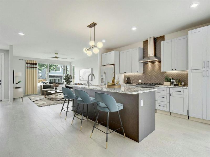 This chef's kitchen features a center island and breakfast bar, providing ample space for meal preparation, casual dining, and socializing with guests. *Virtually Staged*