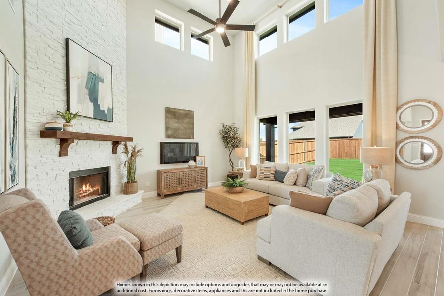 Living room with two-story ceiling, white brick fireplace, ceiling fan, and large windows Living room with two-story ceiling, white brick fireplace, ceiling fan, and large windows