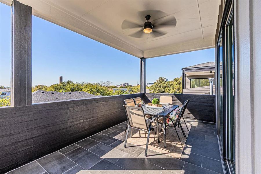 Balcony with a ceiling fan and outdoor dining area Balcony with a ceiling fan and outdoor dining area