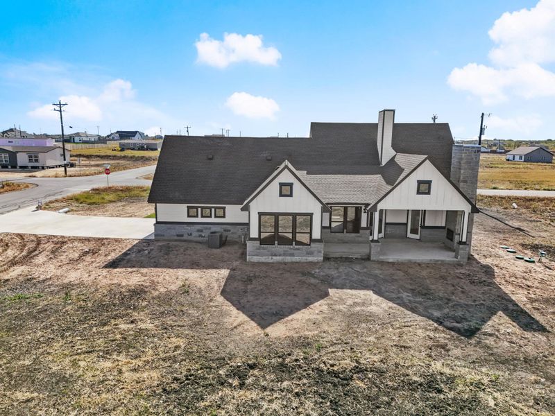 A newly constructed residence features an inviting front facade with a stone chimney, offering both charm and architectural interest. A newly constructed residence features an inviting front facade with a stone chimney, offering both charm and architectural interest.
