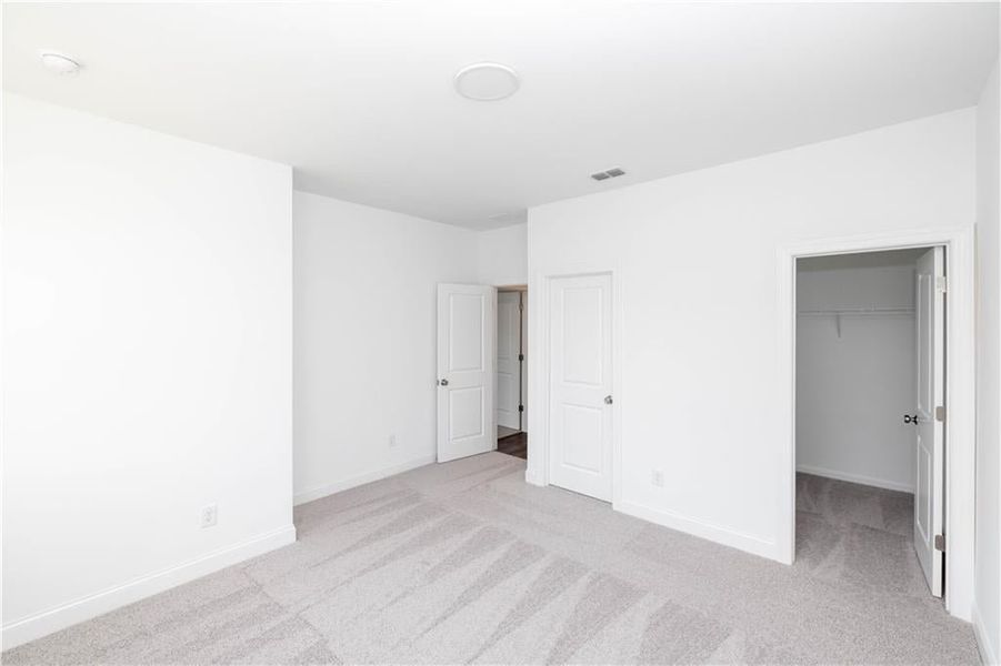 Secondary bedroom with walk in closet - Pictures represent a previously built home, not the actual home.