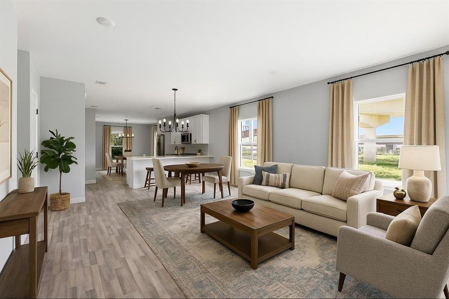 Living area featuring a chandelier and light wood-style floors