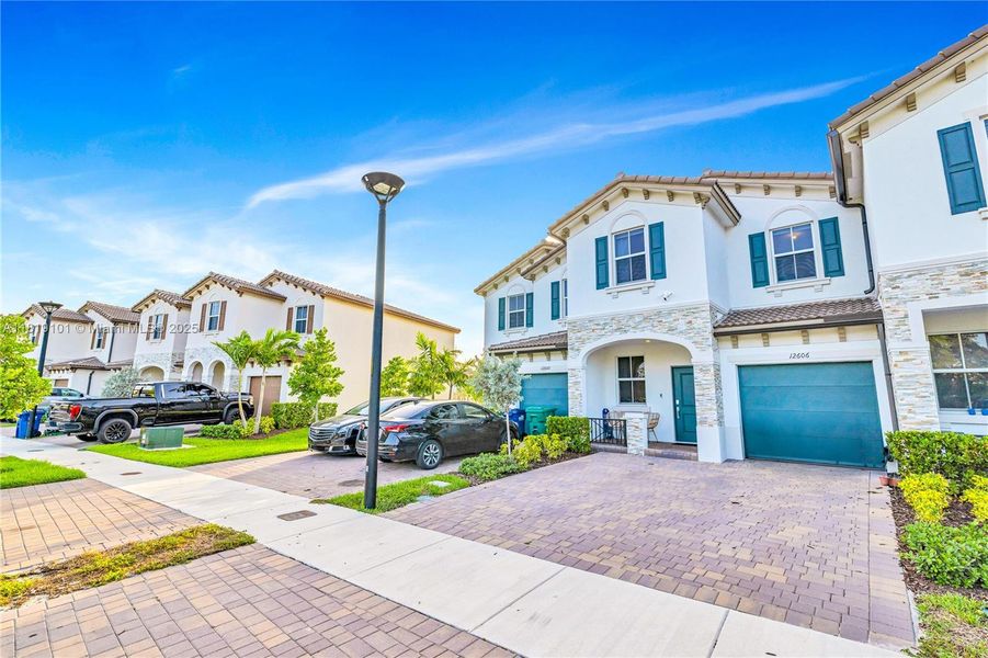 Front exterior of a new home in Westview: Nantucket Collection, Miami, FL, highlighting curb appeal (Image 2). Front exterior of a new home in Westview: Nantucket Collection, Miami, FL, highlighting curb appeal (Image 2).