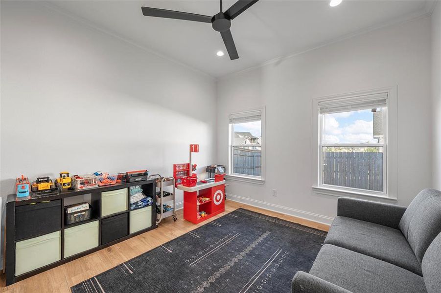 Game room with wood finished floors, crown molding, recessed lighting, and ceiling fan Game room with wood finished floors, crown molding, recessed lighting, and ceiling fan