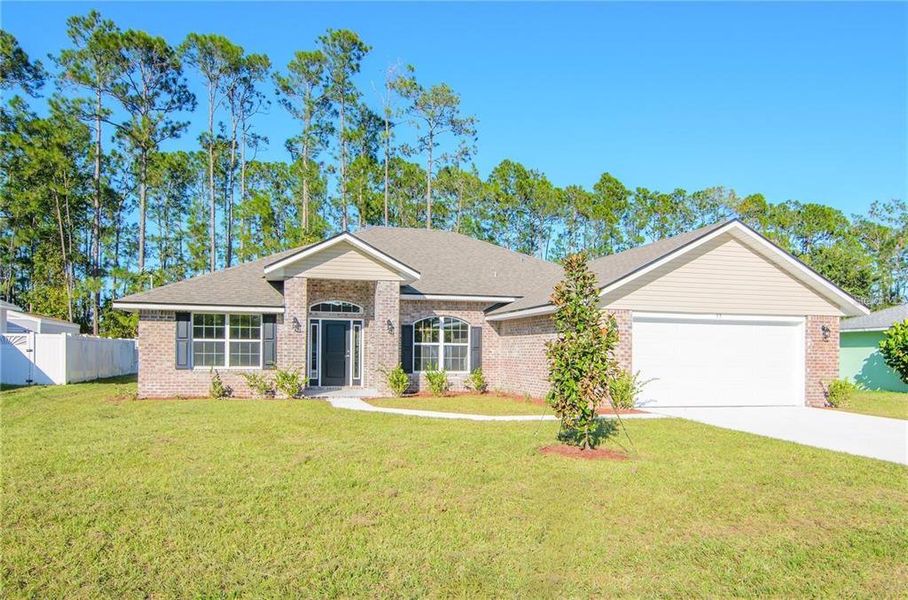 Front exterior of a new home in Palm Coast, Palm Coast, FL, highlighting curb appeal (Image 1). Front exterior of a new home in Palm Coast, Palm Coast, FL, highlighting curb appeal (Image 1).