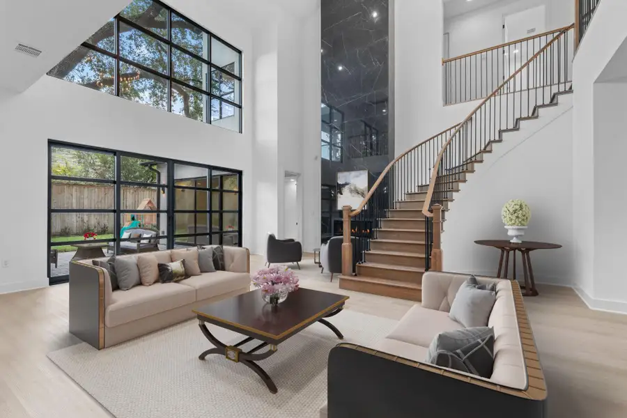 Virtually Staged: Walk through the foyer past the staircase and arrive at this incredible living room! Highlighting stunning floor to ceiling windows. Virtually Staged: Walk through the foyer past the staircase and arrive at this incredible living room! Highlighting stunning floor to ceiling windows.