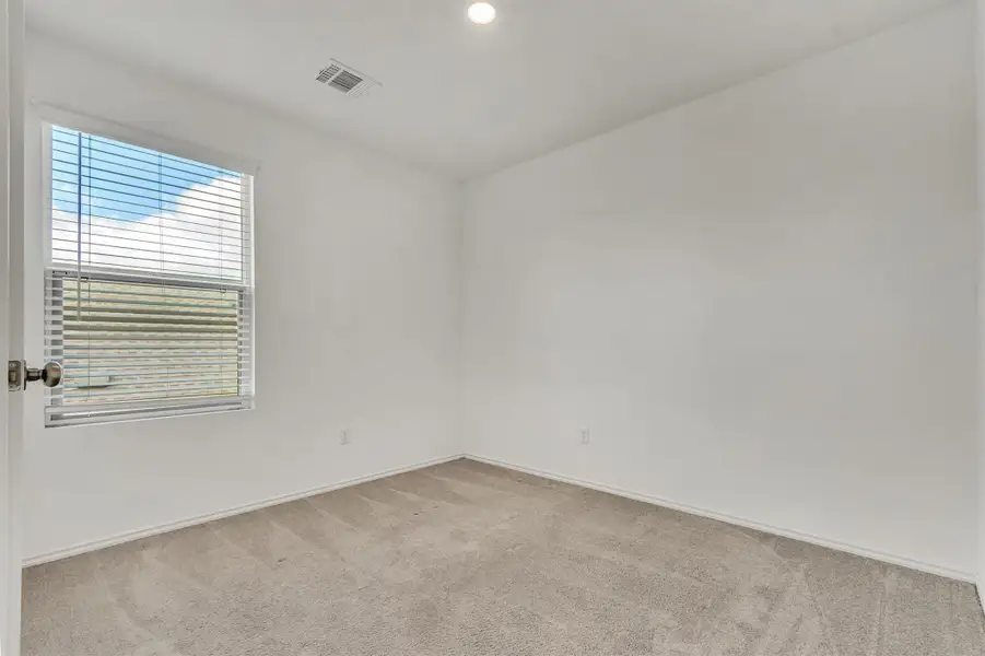 Soft carpeting pairs with recessed lighting in a comfortable, versatile bedroom. Soft carpeting pairs with recessed lighting in a comfortable, versatile bedroom.