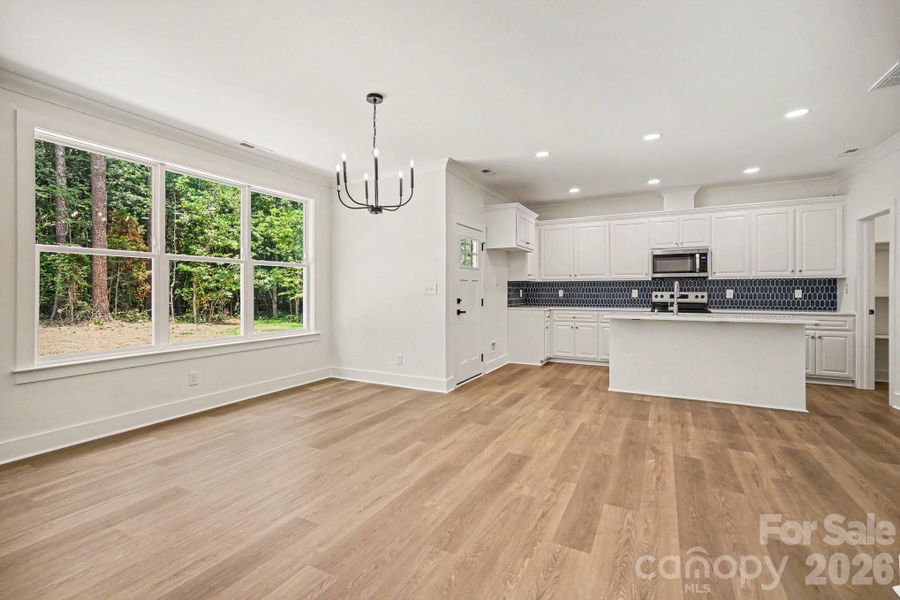 Expansive triple windows overlooking back patio and yard Expansive triple windows overlooking back patio and yard