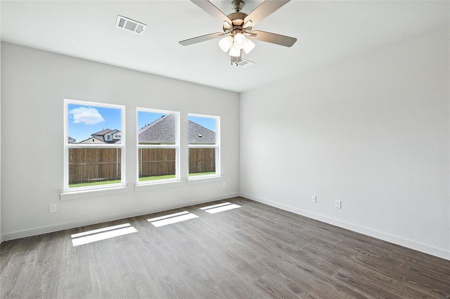 Unfurnished room with wood finished floors and ceiling fan Unfurnished room with wood finished floors and ceiling fan
